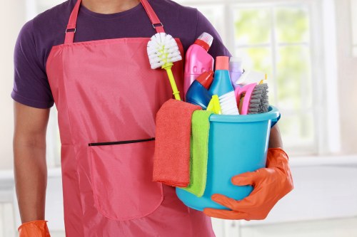 Maidavale Cleaner team member using protective equipment during cleaning