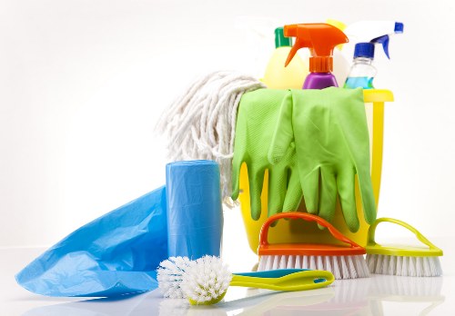 Staff checking cleaning equipment and maintaining a tidy work area