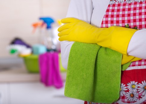 Builders cleaning service in Maidavale polishing glass and clearing debris after renovation